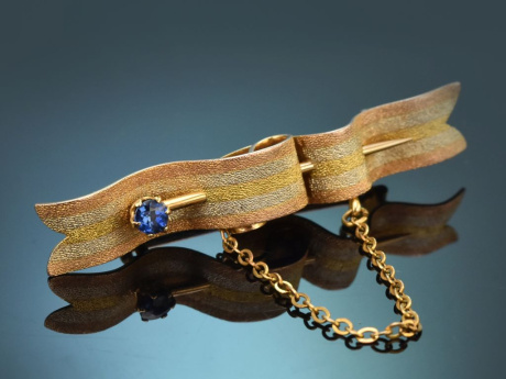Circa 1910! Curved ribbon brooch with a Ceylon sapphire in 14-carat gold