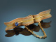 Circa 1910! Curved ribbon brooch with a Ceylon sapphire in 14-carat gold